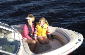 Mom and child (daughter) sitting in the bow of a boat.