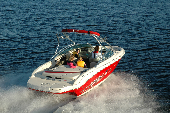 Adult male and female along with boy and girl in a moving motor boat