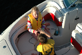 Boy and girl wearing children's life jackets in the bow